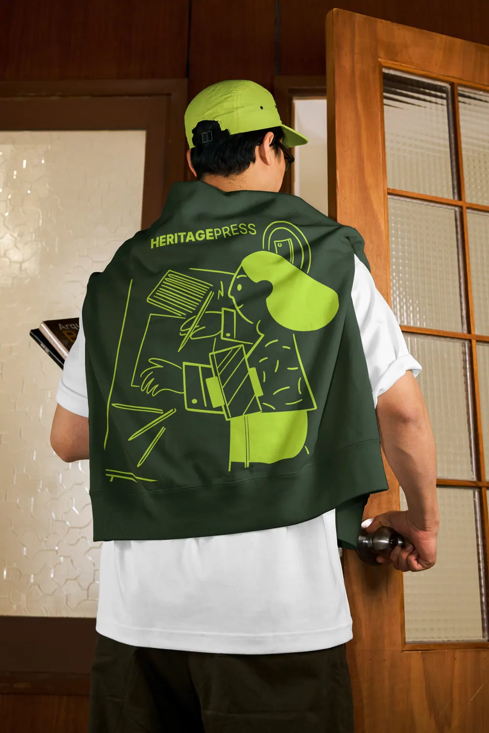 A man in a green jacket with a bold illustrated back print
