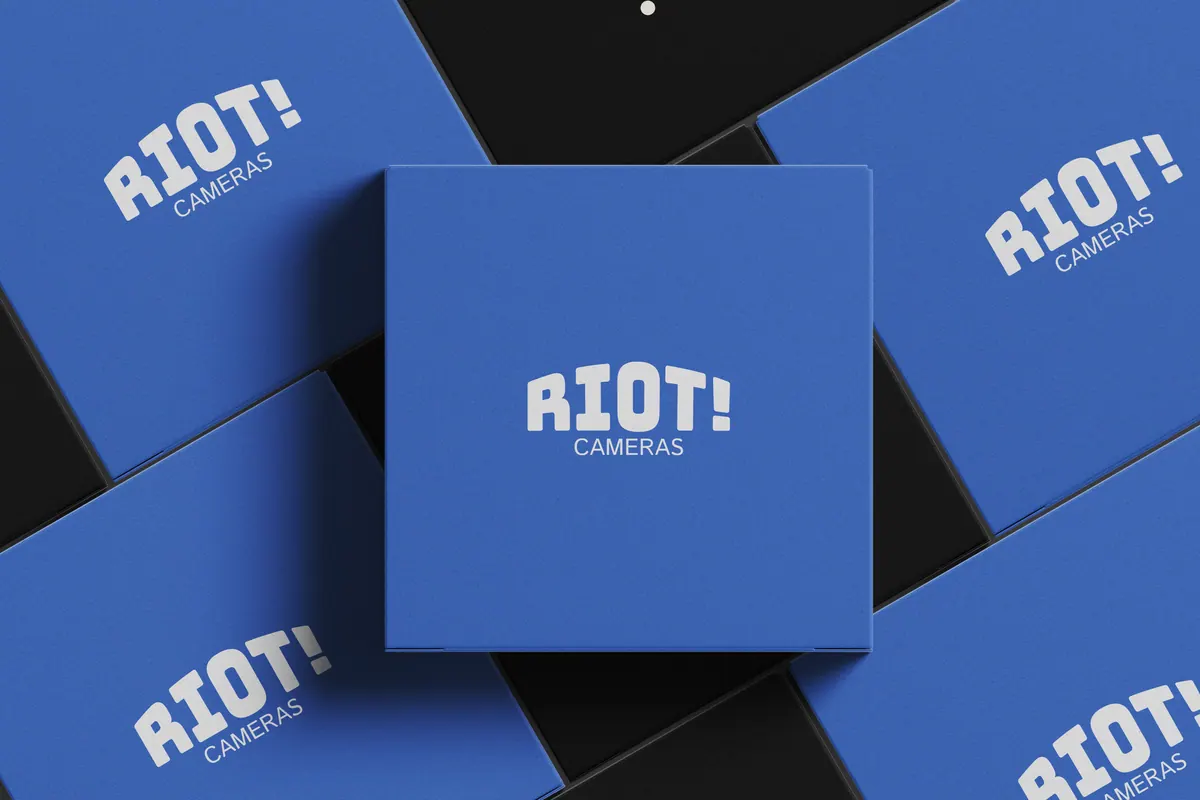 Blue RIOT! Cameras boxes arranged on black