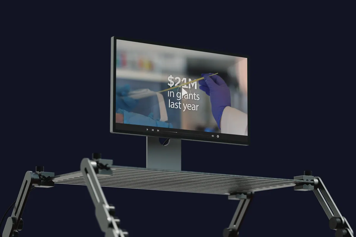 A monitor on a stand showing an animated grants figure